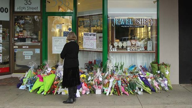 Floral tributes outside the shop of Dermot and Bridget O'Toole.