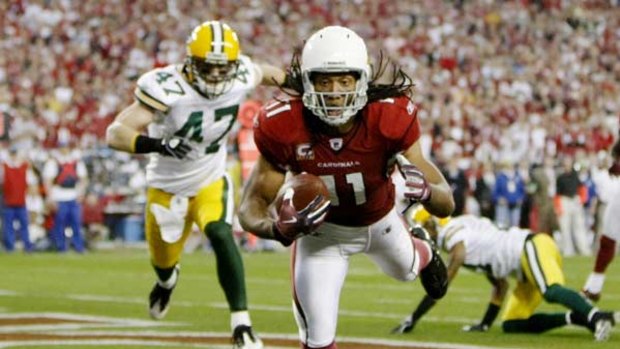 Legs eleven ... Cardinals wide receiver Larry Fitzgerald catches a touchdown pass from quarterback Kurt Warner – one of five – during their game against the Green Bay Packers.