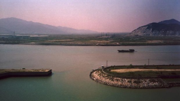A Chinese industrial barge makes its way up a canal between China and Macau.