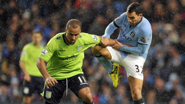 Manchester City's Carlos Tevez (right) and Aston Villa's Gabreil Agbonlahor,  battle during their English League Cup third-round match.