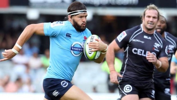 Big hit-up: Adam Ashley-Cooper makes a bust for the Waratahs against the Sharks in Durban.