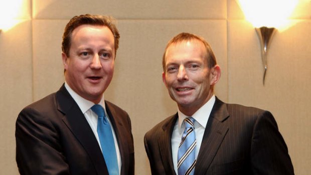 Swapping notes ... British Prime Minister David Cameron with Liberal leader Tony Abbott.