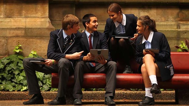 Screen test &#8230; Harry Sanderson, 14, Reggie Ridlen, 15, Claire Darwell, 15, and Helena Salomon, 14, with their iPad yesterday.