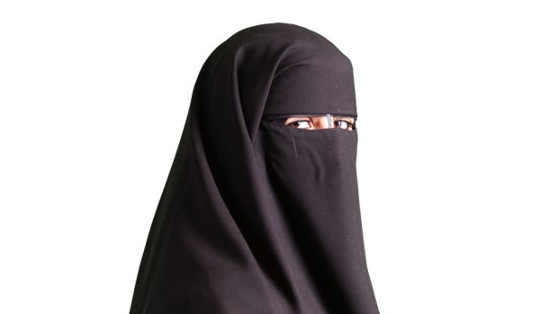 A woman wearing a black niqab.