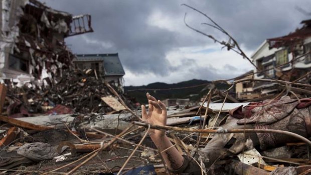 The arm of a mannequin sticks out from the rubble in a devastated neighborhood in Kesennuma, Miyagi prefecture, in north-eastern Japan.