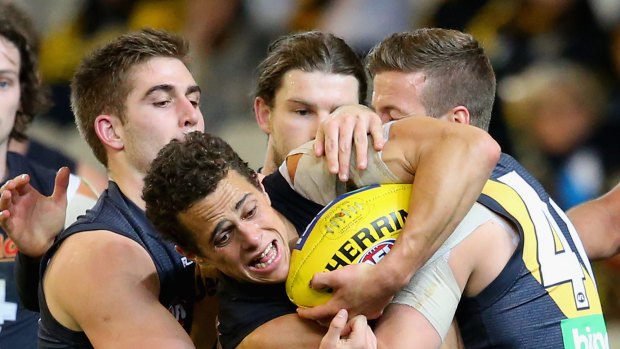 Ed Curnow of the Blues is tackled by Tigers Anthony Miles and Kane Lambert.