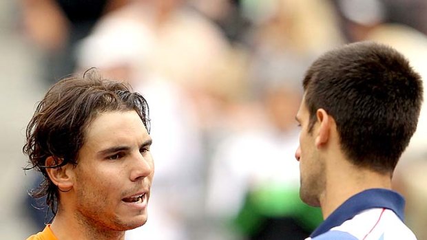 Rafael Nadal of Spain congratulates Novak Djokovic of Serbia after the match.