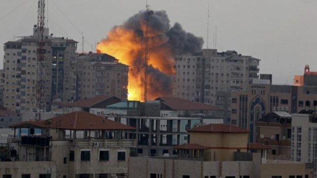 A ball of fire rises in Gaza City following an Israeli air strike on Saturday.