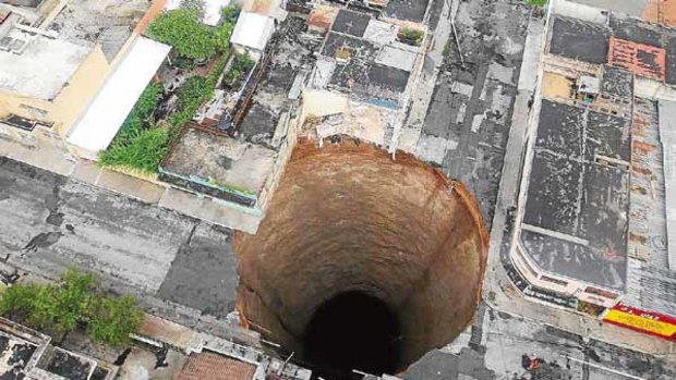 The  sinkhole covers a street intersection in Guatemala City.