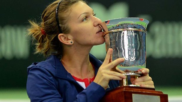 Romania's Simona Halep kisses her trophy after her victory over Samantha Stosur in the Kremlin Cup final on Sunday.