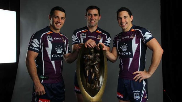 Storming it up: Melbourne's Cooper Cronk (left), Cameron Smith and Billy Slater at the grand final breakfast yesterday.