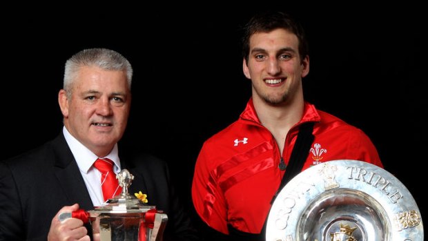 Wales coach Warren Gatland and Wales captain Sam Warburton pose with the Six Nations Trophy and the Triple Crown trophy.