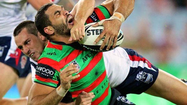 Mitchell Pearce grapples with Greg Inglis during last year's clash at ANZ Stadium.
