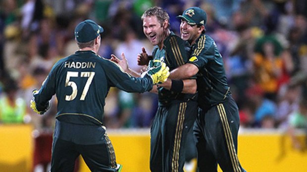 Five-wicket man Ryan Harris celebrates with Brad Haddin and Ricky Ponting after dismissing Rana Naved for 33.
