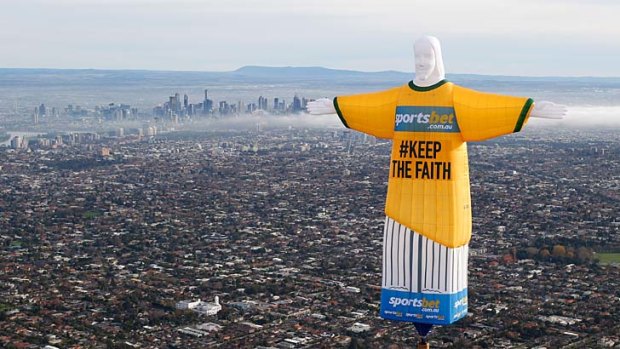 Words from on high: The Sportsbet balloon copy of Rio's Christ the Redeemer flies over Melbourne.