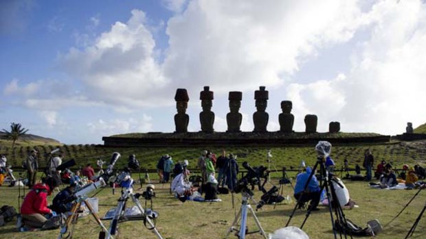 Tourists and  scientists prepare their equipment  before a solar total eclipse on Easter Island.