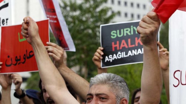 The struggle continues ... demonstrators shout slogans against Syrian President Bashar al-Assad in front of the Syrian Embassy in Turkey.