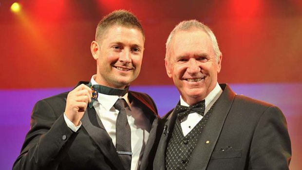 Michael Clarke with Allan Border after receiving the medal.