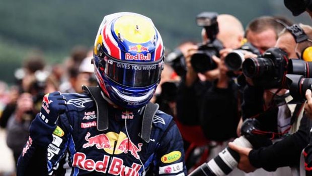 Mark Webber celebrates after finishing first during qualifying for the Belgian Formula One Grand Prix at the Circuit of Spa Francorchamps.