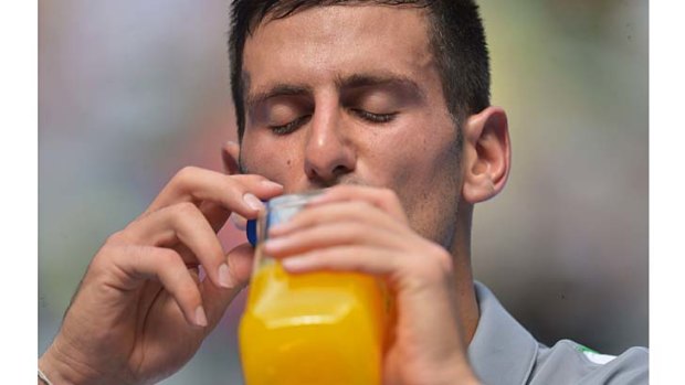 Novak Djokovic keeps himself hydrated during his match against Leonardo Mayer.