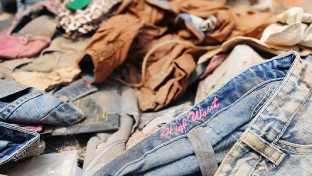 Clothes lie in the rubble of a collapsed  Bangladeshi garment factory. Oxfam claim it is just a matter of time before an Australian label is found there.