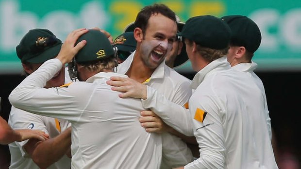 Key man: Nathan Lyon is swamped by teammates after dismissing Ian Bell.