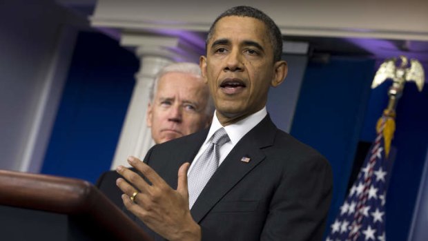 President Barack Obama talks about tackling gun violence as Vice President Joe Biden looks on.