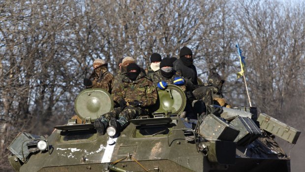 Ukrainian government soldiers on a road stretching away from the town of Artemivsk, Ukraine, towards Debaltseve.