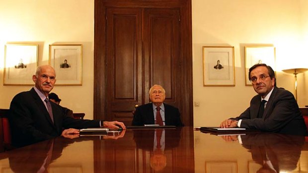 Greece's Prime Minister George Papandreou, left, Greek President Karolos Papoulias, center and opposition leader Antonis Samaras meet to discuss a new government.