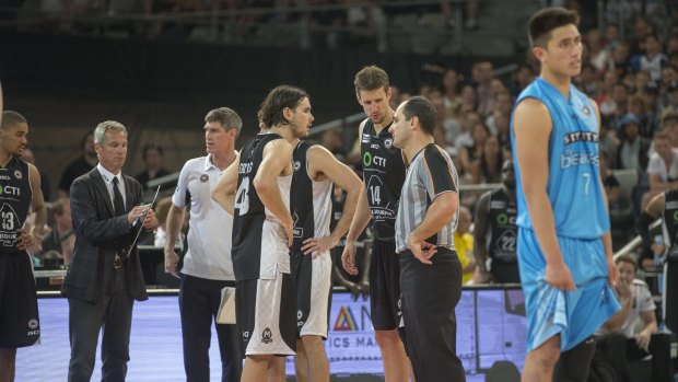 Controversial finish: Play stops while referees ponder the consequences of fouls in the final seconds of the game between Melbourne United and New Zealand Breakers. 