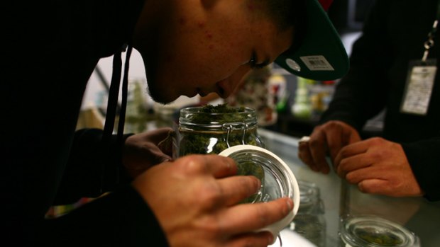 A buyer smells the merchandise at a Good Meds medical cannabis centre.