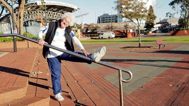 89-year-old Lee Nilon stretches her hamstring in Bunbury this morning before heading off.