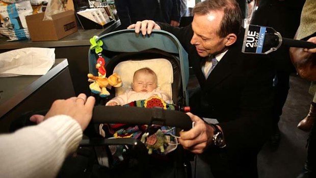 Opposition Leader Tony Abbott courts a future voter during a street walk in Geelong on Tuesday.