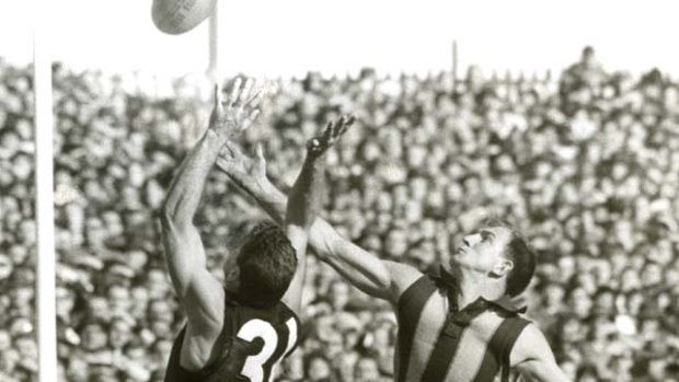 Carlton's new captain-coach Ron Barassi flies against Hawthorn player Rod Olsson in 1965.