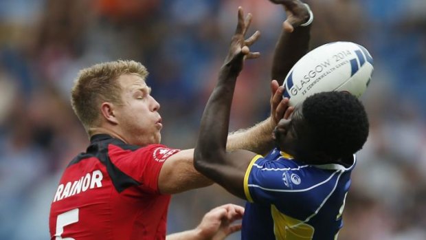 Barbados' Dario Stoute fights for possession against Canada's Conor Trainor.