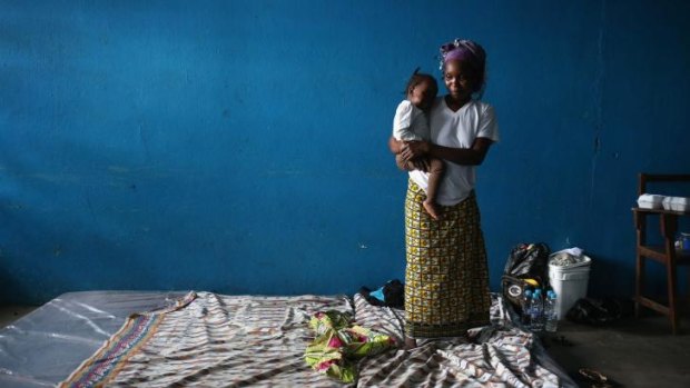 A mother and child in a classroom now used as an Ebola isolation ward in Monrovia, Liberia.