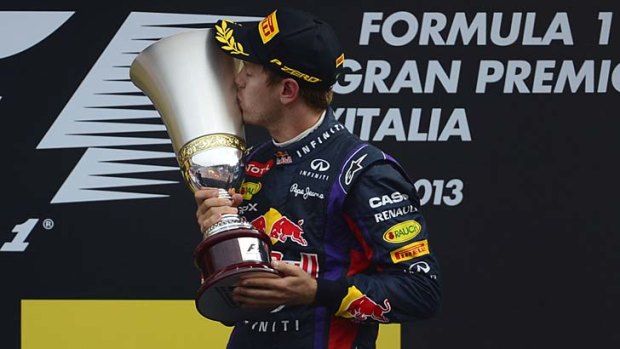 Red Bull's Sebastian Vettel kisses his trophy on the podium after winning the Italian GP at Monza on Sunday.