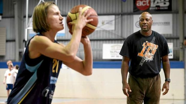 Canberra Capitals player Jess Bibby works on her shooting technique with David Jones.