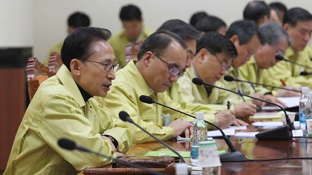South President Lee Myung-Bak presides over the emergency Cabinet meeting.