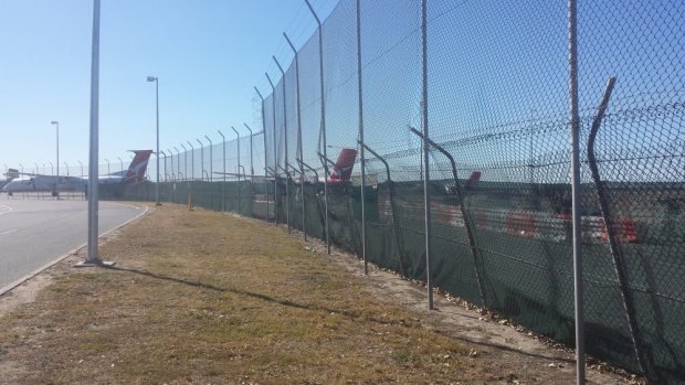 The fence area breached when a woman drove a car onto the Brisbane Airport airfield. 