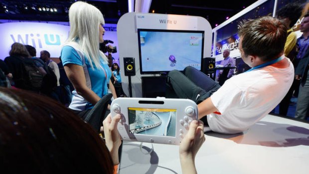 Fans play new games on the Wii Fit U at the E3 expo.