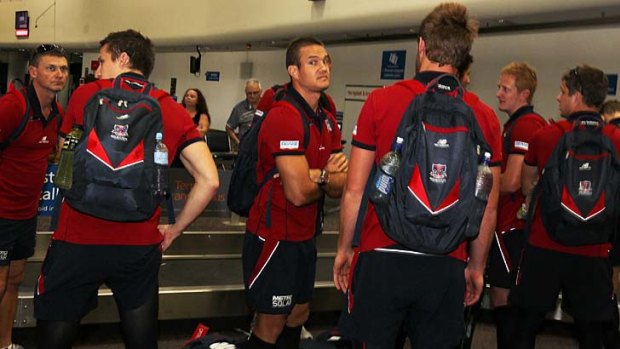 Melbourne Football Club players (Brad Green, centre) on the team's arrival at Perth Airport.