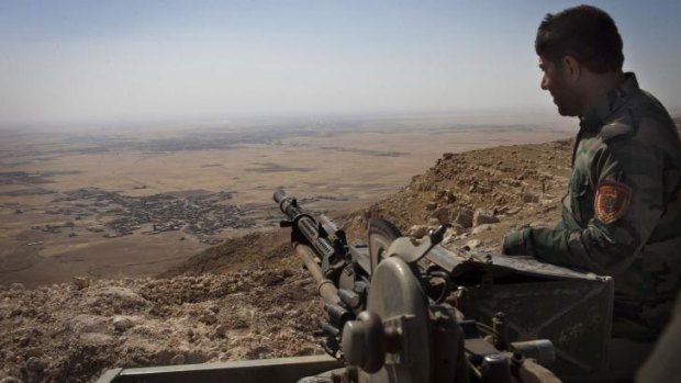Vantage point: An Iraqi Kurdish Peshmerga fighter on the top of Mount Zardak, a strategic point about 25 kilometres east of Mosul taken on September 6.