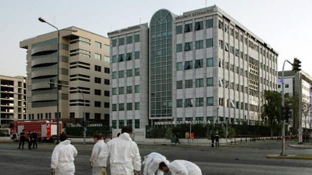 Investigators collect evidence after a powerful bomb exploded at the Athens Stock Exchange.
