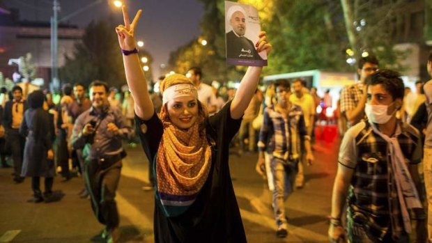 Winds of change: A supporter of moderate cleric Hassan Rouhani celebrates his presidential election win in Iran's capital, Tehran.