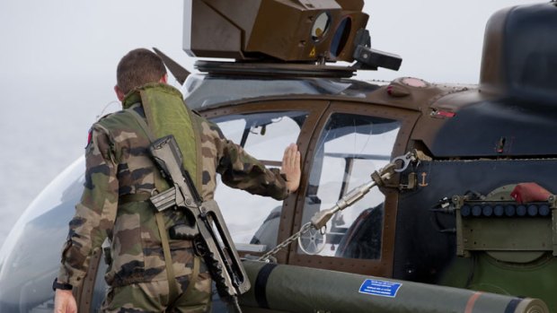 New phase ... a member of the French military prepares an attack helicopter for its first military operation in Libya.