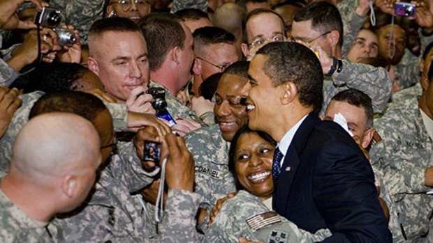 Offering the thanks of a grateful nation ... Barack Obama mingles with troops at Camp Victory in Iraq.