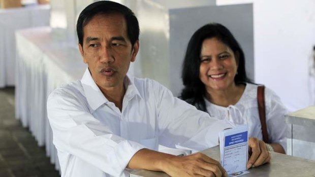 Jakarta governor Joko Widodo and his wife Iriana cast their ballots.