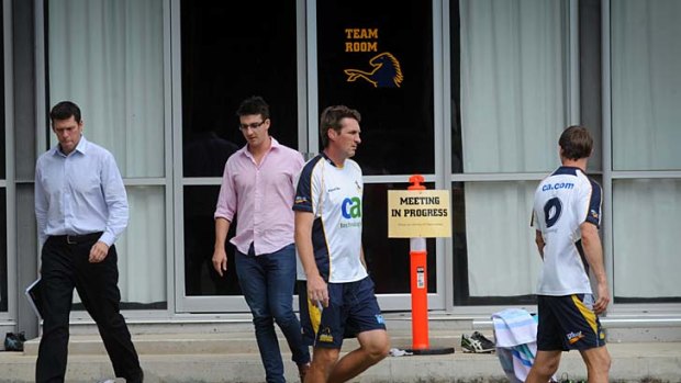 Marching orders ... Brumbies CEO Andrew Fagan, left, and coaching staff Justin Harrison and Stephen Larkham leave the meeting at which it was announced  coach Andy Friend was sacked.