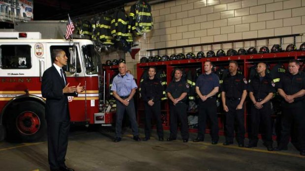 Barack Obama talks to firefighters at the Engine 54 firehouse in Times Square, New York.